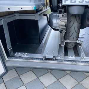Motorroller steht auf stabiler Halteschiene in der Wohnmobil-Heckgarage